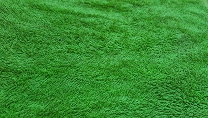 Soft green fleece fabric texture background, close-up of fluffy textile material surface, vibrant green microfiber cloth for fashion and upholstery © عبد الحليم سراط
