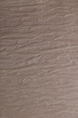 Obraz premium Texture of a wooden surface seen in a close-up as light creates shadows on the grooves of the wood during daytime