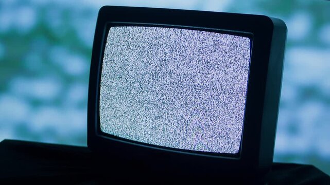 Retro TV, vintage television In a nostalgic setup, a retro TV displays grain on screen, scary halloween night device good for chroma key and green screen.