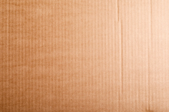Detailed close-up of brown corrugated cardboard texture. Perfect for backgrounds, packaging, recycling concepts, and rus