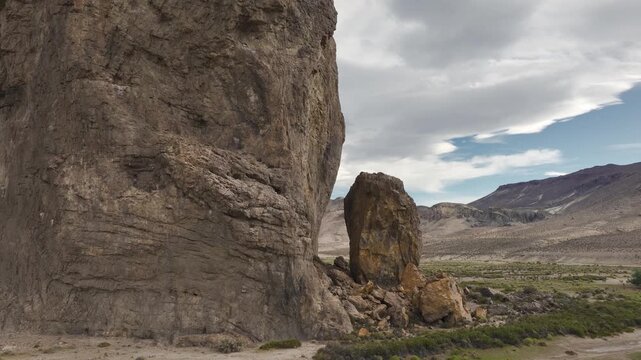 Wide aerial orbit shot of the massive and imposing Piedra Parada rock formation in the arid steppe of Chubut, Patagonia, Argentina