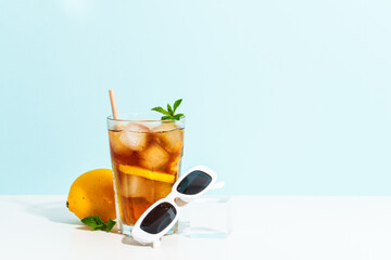 Summer cold drink on colored background with hard shadows.