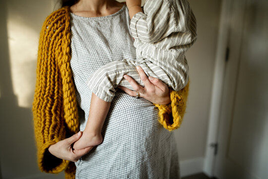 Pregnant Mother holding Toddler