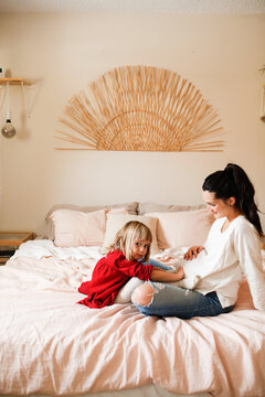 Mother Hanging out with daughter on bed