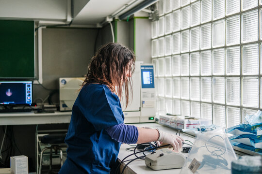 Veterinarian technician working with medical equipment in clinic