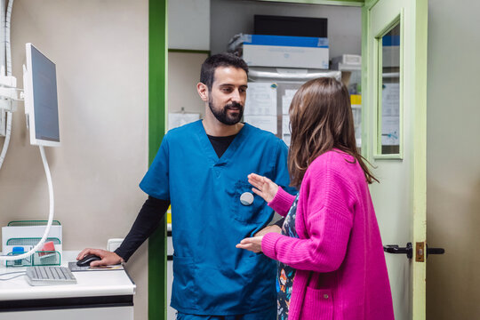 Veterinarian consulting woman in a modern animal clinic office