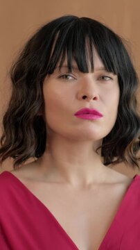 Elegant Confident Portrait. Stylish Woman With Poised Expression. Sophisticated Female Model Showcasing Confidence And Style. Charming Caucasian Woman In Vibrant Attire Exudes Elegance And Poise
