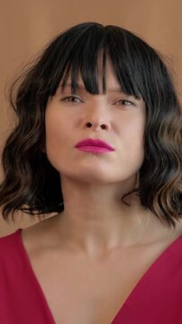 Intimate Caucasian Woman In Red Dress, Eyes Closed With Pensive Head Tilt, Soft Warm Backdrop, Short Black Bob With Bangs, Pink Lipstick, Cinematic Side Lighting, Introspective Mood, Vulnerable