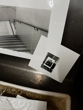 Stacked Prints Resting on a Silver Table After a Creative Session