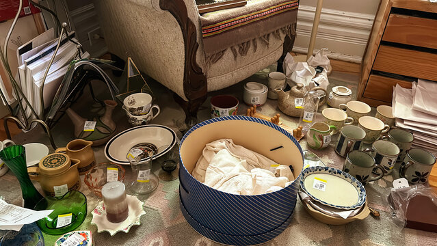 Items Are Scattered Around a Room With a Chair and Various Objects