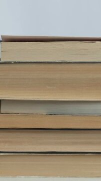 Arrangement Of Textbooks Along Table Edge. Classroom Scene With Textbooks Aligned Neatly On Table Edge. Scholarly Setting Showcasing Stacked Books With Visible Spine And Page Textures