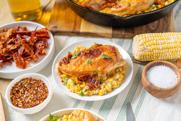 Cast-iron chicken and creamed corn with bacon. Heavy dinner food © Jeremy Pawlowski