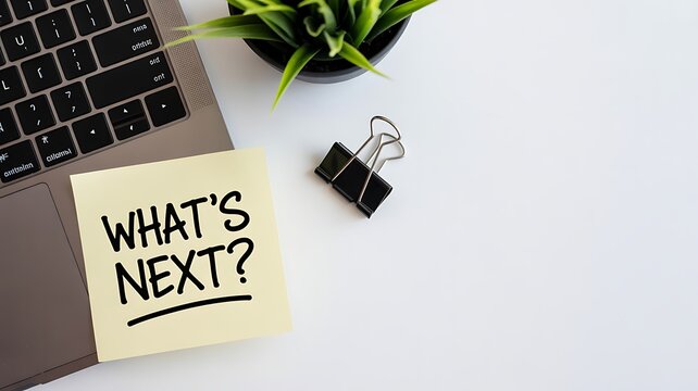 Curiosity and planning with an open laptop and sticky note asking what's next