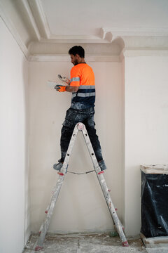 Worker On Ladder Indoors