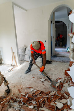 Worker Shoveling Debris