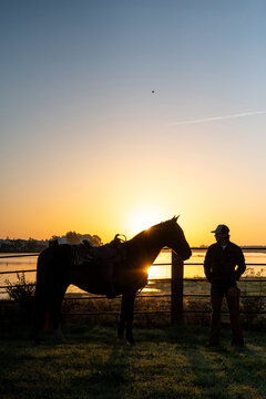Cowboy And Mustang Framed By Rising Sun
