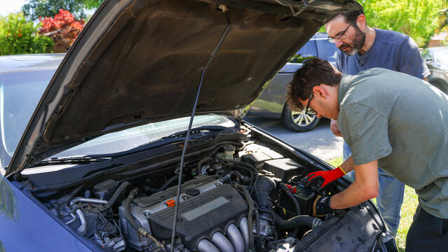 Father and Son Fixing a Car