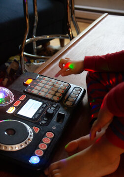 Child Creates Music Using a Colorful DJ Equipment Setup at Home