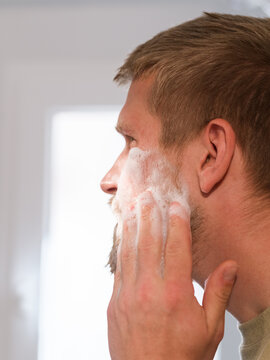 Man cleansing face with foam