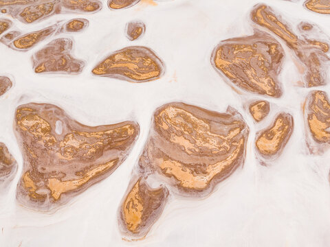 Aerial view of parched earth islands amidst a sea of white salt, creating a stark yet beautiful contrast, Lake Campion Nature Reserve, Western Australia, Australia.