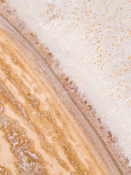 Aerial view of a stunning blend of textures and colors, where earthy tones meet pale sands, creating a mesmerizing landscape from above, Lake Campion, Western Australia, Australia.