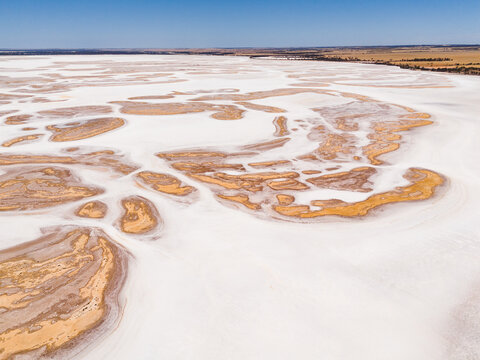 Aerial view of the stark white salt lake contrasting with the earthy tones of the surrounding landscape, Lake Campion Nature Reserve, Western Australia, Australia.