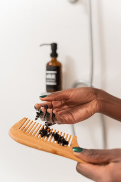Woman collecting broken hair from comb