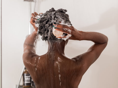 Woman using shampoo bar in shower