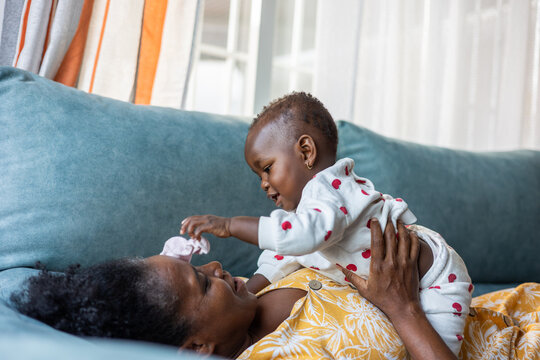 a woman playing at home with her baby