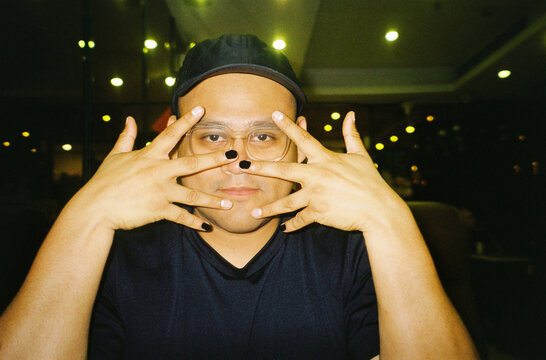 Portrait of a man showing off his painted nails