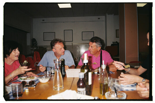 Friends Enjoying a Meal Together at a Gathering in a Cozy Setting