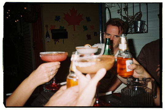 Celebration With Drinks and Laughter at a Social Gathering