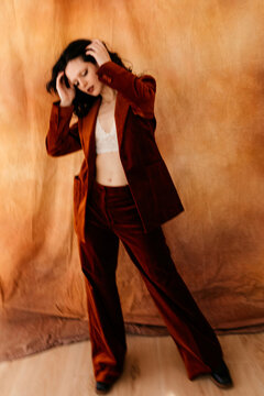 Woman in velvet suit with dynamic movement
