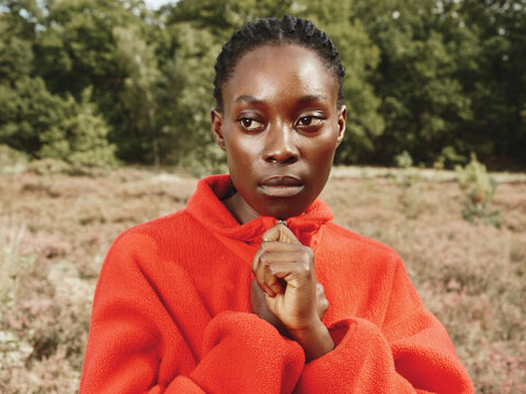 Black Woman Hiking in Red Fleece in Autumn Field