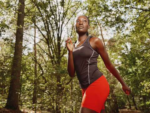 Woman Jogging in a Forest During Daylight Hours
