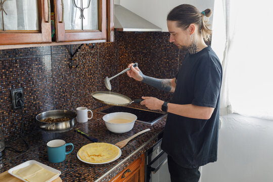 Young father frying pancake