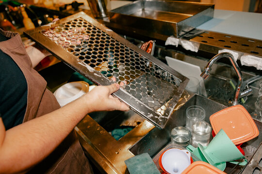 Bartender Cleaning Bar Equipment