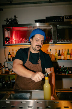 Bartender Removing Pour Spout from Bottle
