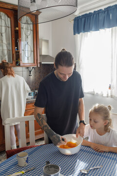 Little boy and parents are preparing lunch