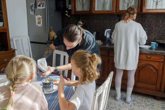 Children and parents cooking at home