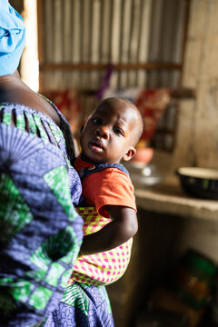 Senegalese mother carrying baby in traditional fabric