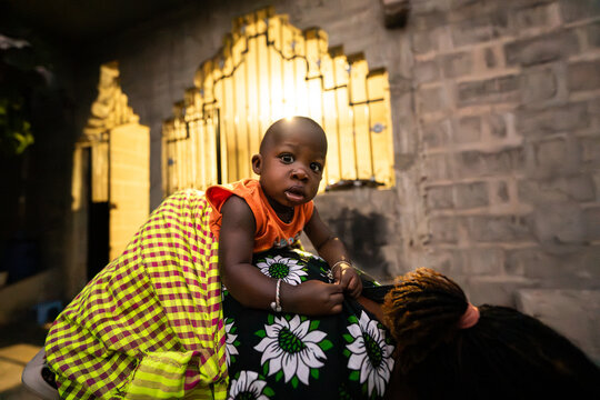 Baby riding mother's back in Senegal Africa