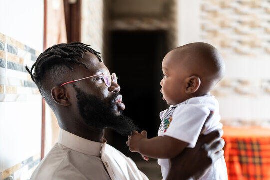 African father bonding with baby in Senegal