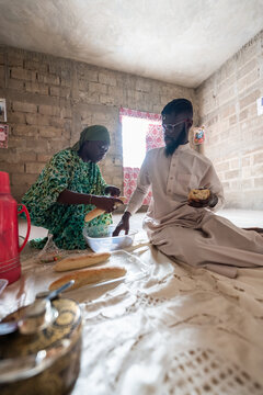 Senegalese couple sharing traditional meal with bread