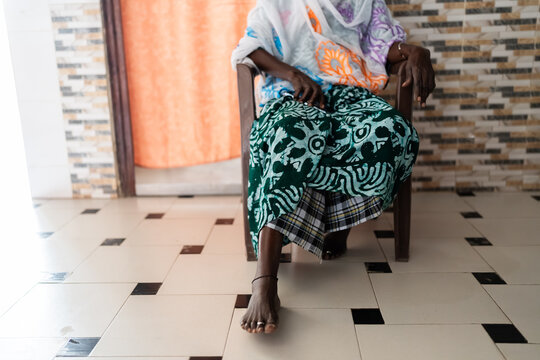 Senegalese woman sitting wearing traditional clothes