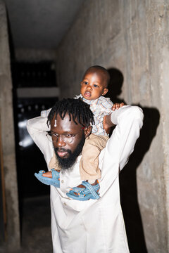 Father carrying son piggyback in Senegal Africa