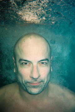 Man submerging Underwater in Blue atmosphere