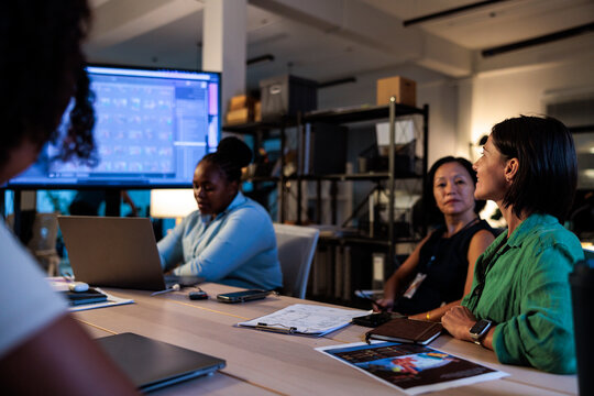 Diverse team collaborates on a project in a modern office.