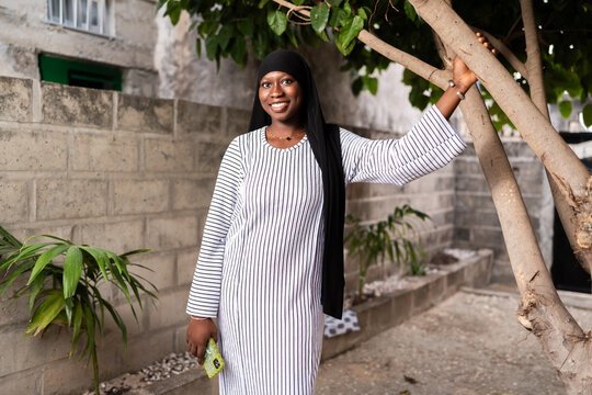 Smiling African woman wearing hijab outdoor in Senegal