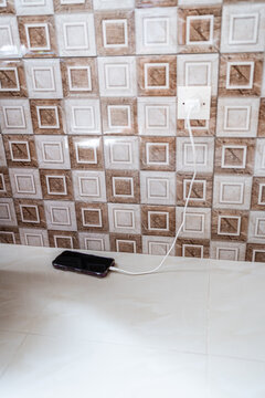 Smartphone charging from wall outlet in Senegal